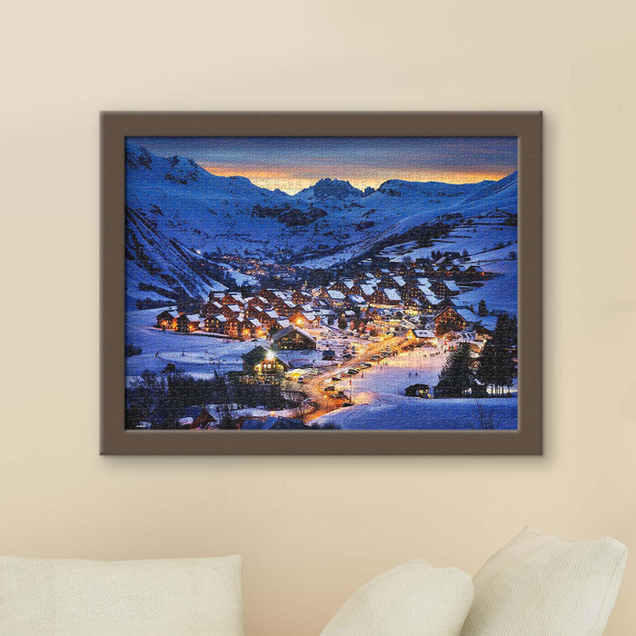 In the heart of the Alps, winter lights twinkle as miniature towns rest beneath majestic peaks.