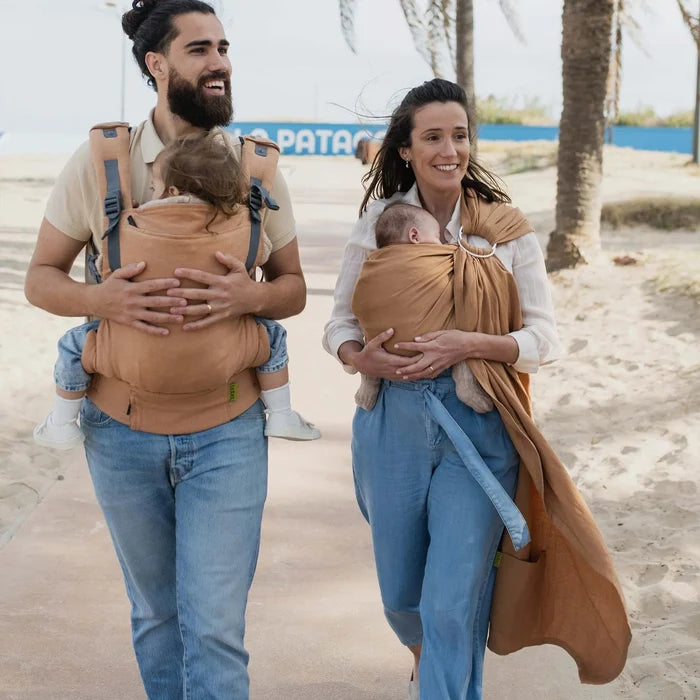 A Boba Ring Sling Baby Carrier made from a unique linen bamboo viscose fabric blend, perfect for all seasons. Lightweight and breathable, it stores compactly, ideal for newborn snuggles to toddler ups and downs (8 - 35Ibs). Rye Brown