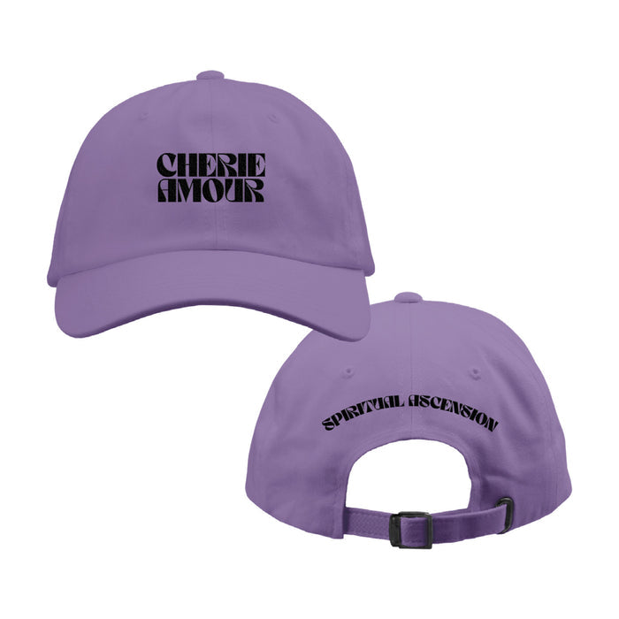 Lavender colored baseball hat. On the front of the hat reads CHERIE AMOUR in Black letters. On the back of the hat, it reads SPIRITUAL ASCENSION in smaller black letters.