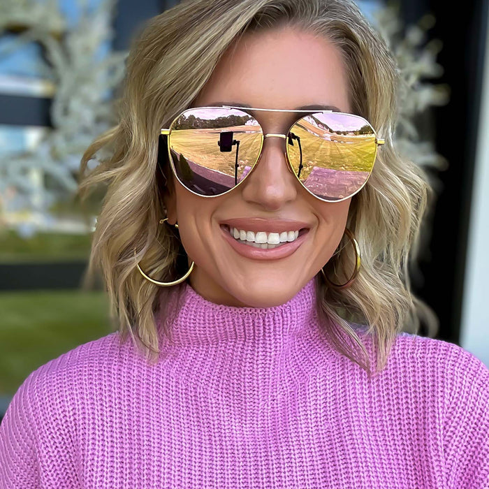 lifestyle - kalee rogers wearing diff eyewear dash aviator sunglasses with a rose gold frame cherry blossom mirror polarized lenses