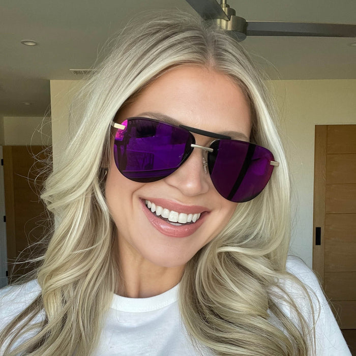 lifestyle - maggiehjackson wearing diff eyewear tahoe aviator sunglasses with a matte gold metal frame and sunset mirror lenses angled view