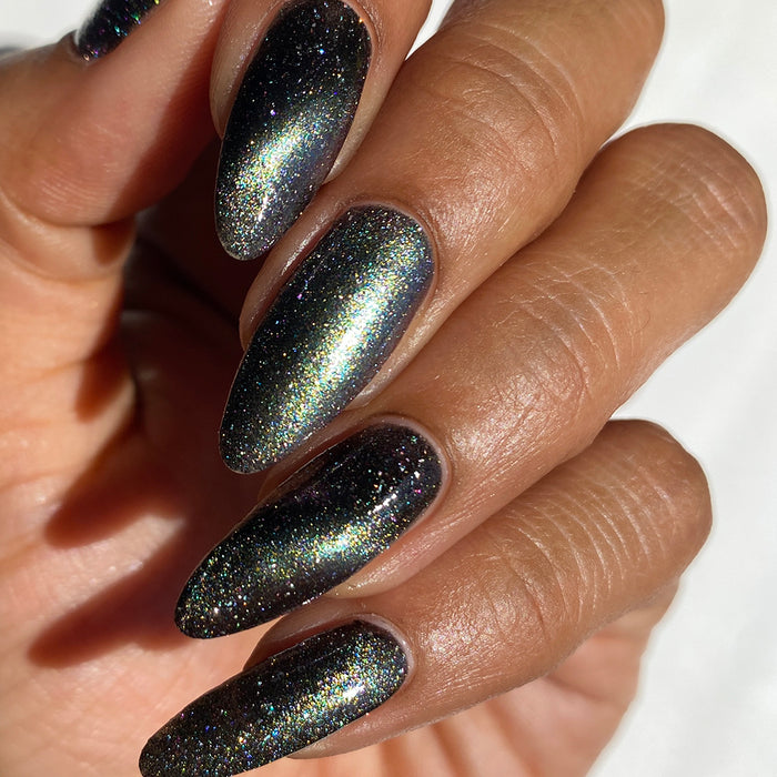 Close-up of nails painted with Tombstone Nail Lacquer on medium skin tone.
