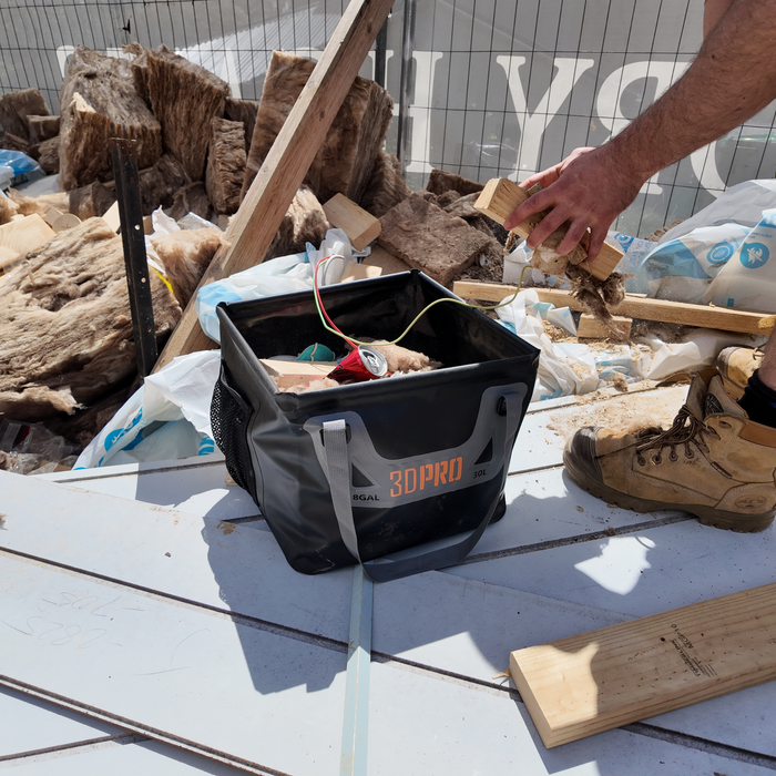 Person working with a 3DPro 15L/4GAL Pro Square Folding Bucket on a construction site