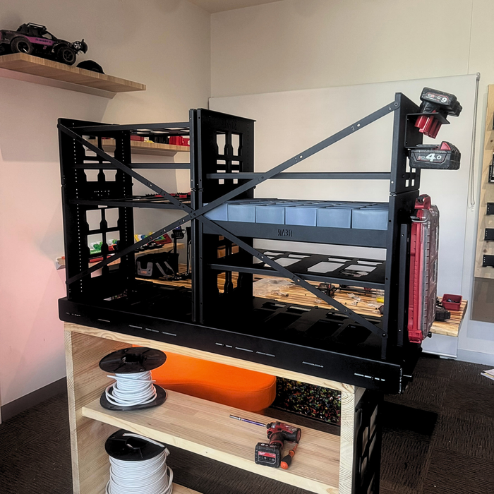 Black metal shelving unit with 2.0 Slider Bracing Kit (Pack A Shelf) in a room setting.