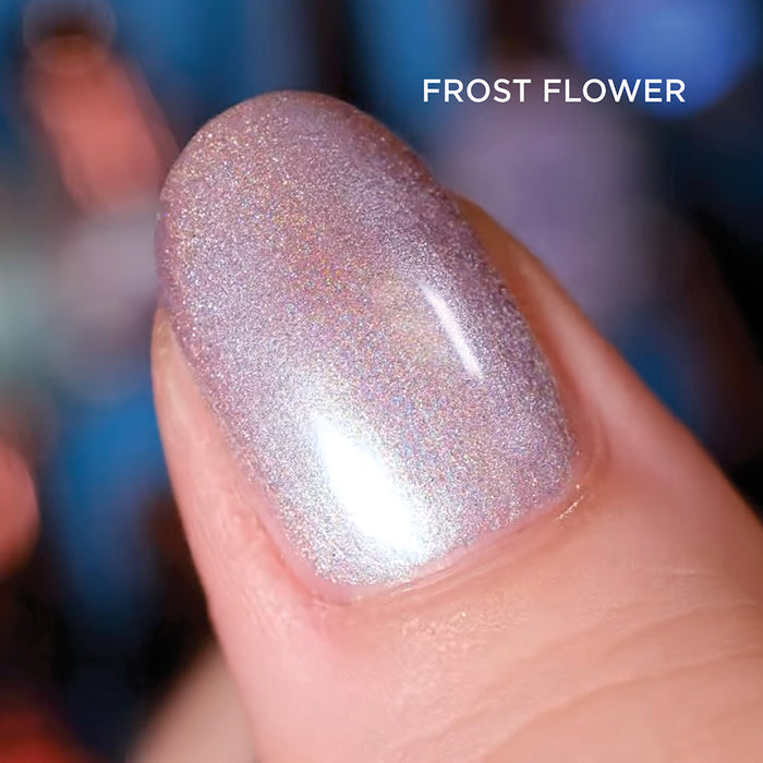 Close-up of one nail painted with Frost Flower Nail Lacquer, on a dark blurred background.