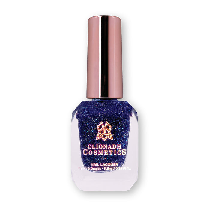 Bottle of nail polish containing Navy Goldstone on white background.
