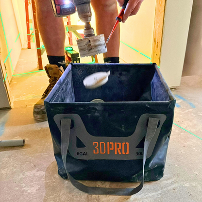 Person using a 30L/8GAL Pro Square Folding Bucket in a construction setting