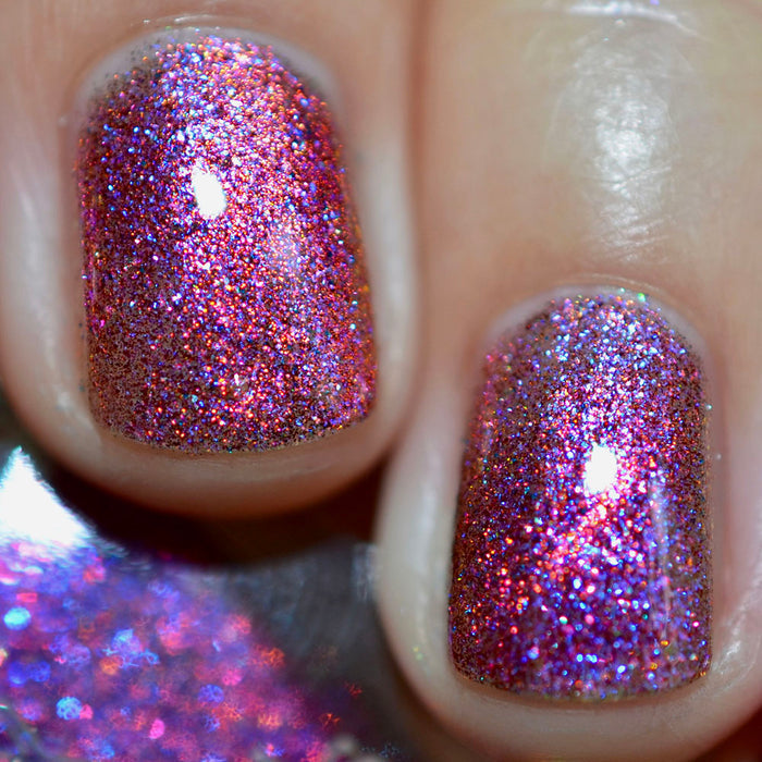 Close-up of two nails painted with Amorem Nail Lacquer. Empasizes pink and purple glitter particles.