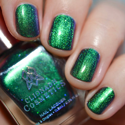 Close-up of nails painted with Anneal Nail Lacquer on fair skin tone. Hand is holding polish bottle.