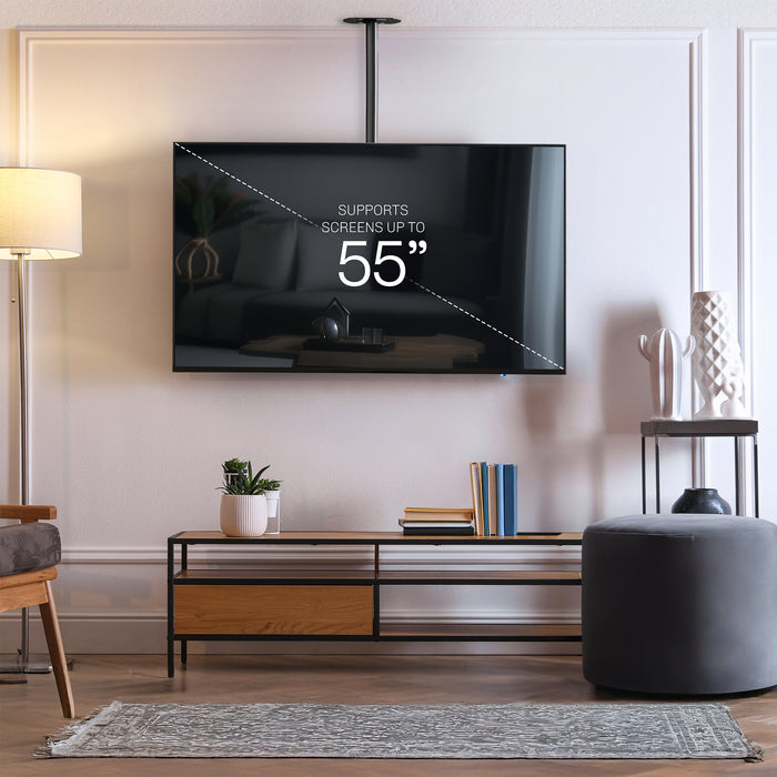 Articulating ceiling TV mount in black color in a modern living room setting.