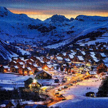 In the heart of the Alps, winter lights twinkle as miniature towns rest beneath majestic peaks.