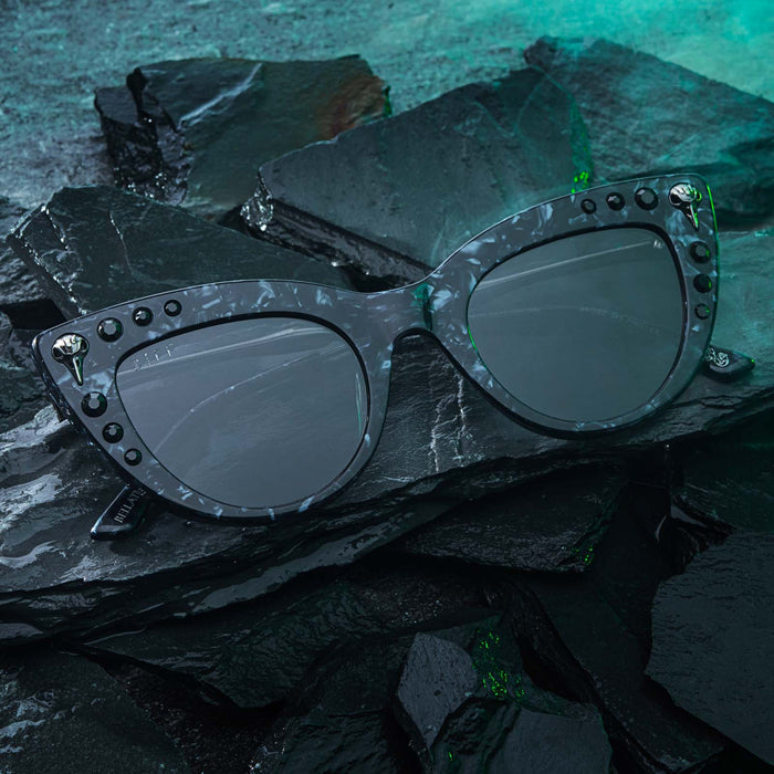 lifestyle - harry potter x diff eyewear bellatrix cateye sunglasses laying on rocks