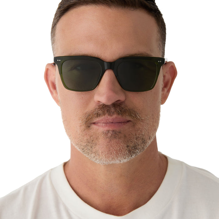 on model - male wearing diff eyewear featuring the billie square sunglasses with a dark olive green crystal frame and g15 polarized lenses front view