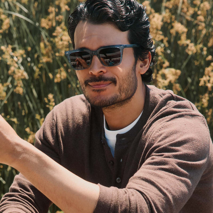 lifestyle - male outdoors wearing diff eyewear billie square sunglasses in night sky blue frame with grey polarized lens front view