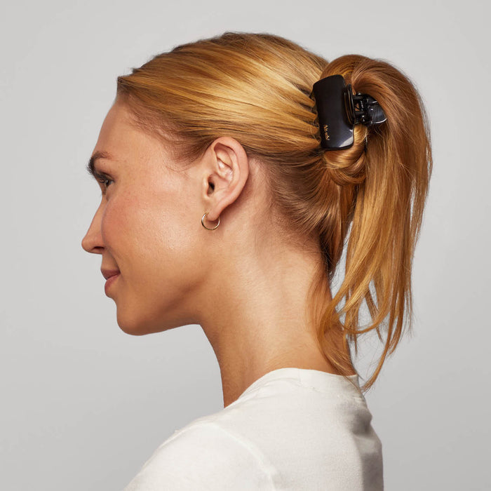 Model wearing a tortoise Cloud Claw Clip in a ponytail