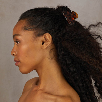Model wearing the tortoise Cloud Claw Clip in curly hair
