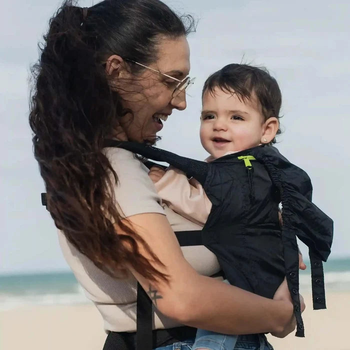 A lightweight, Boba Air Baby Travel Carrier with padded mesh straps, leg openings, adjustable shoulder straps, and an integrated hood. Compact and self-storing, it fits babies 4-24 months (15+ lbs) and children up to 45 lbs, Black