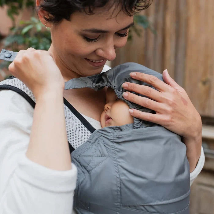 A lightweight, Boba Air Baby Travel Carrier with padded mesh straps, leg openings, adjustable shoulder straps, and an integrated hood. Compact and self-storing, it fits babies 4-24 months (15+ lbs) and children up to 45 lbs, Gray
