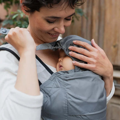 A lightweight, Boba Air Baby Travel Carrier with padded mesh straps, leg openings, adjustable shoulder straps, and an integrated hood. Compact and self-storing, it fits babies 4-24 months (15+ lbs) and children up to 45 lbs, Gray