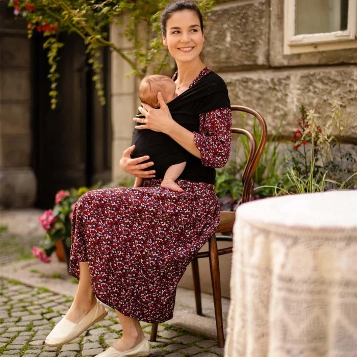 A Boba Classic Baby Wrap, made from a soft 95% French Terry cotton blend and 5% Spandex. Ergonomic, award-winning design fits babies from 7 Ibs to 35 Ibs, best up to 20 Ibs. Machine washable, dryer friendly, and certified hip-healthy. Black