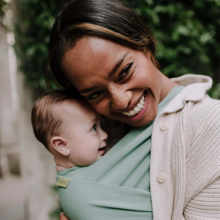 A Boba Classic Baby Wrap, made from a soft 95% French Terry cotton blend and 5% Spandex. Ergonomic, award-winning design fits babies from 7 Ibs to 35 Ibs, best up to 20 Ibs. Machine washable, dryer friendly, and certified hip-healthy. Sage Green