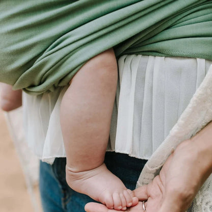 A Boba Classic Baby Wrap, made from a soft 95% French Terry cotton blend and 5% Spandex. Ergonomic, award-winning design fits babies from 7 Ibs to 35 Ibs, best up to 20 Ibs. Machine washable, dryer friendly, and certified hip-healthy. Sage Green