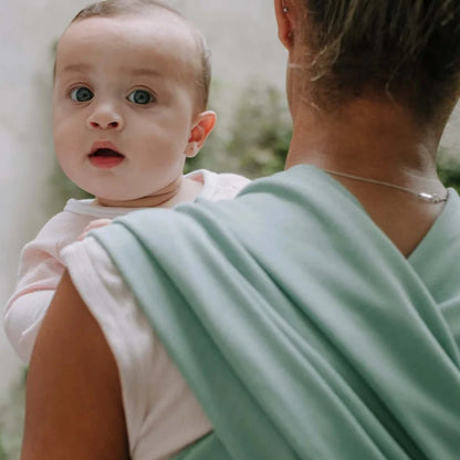 A Boba Classic Baby Wrap, made from a soft 95% French Terry cotton blend and 5% Spandex. Ergonomic, award-winning design fits babies from 7 Ibs to 35 Ibs, best up to 20 Ibs. Machine washable, dryer friendly, and certified hip-healthy. Sage Green