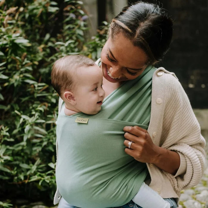 A Boba Classic Baby Wrap, made from a soft 95% French Terry cotton blend and 5% Spandex. Ergonomic, award-winning design fits babies from 7 Ibs to 35 Ibs, best up to 20 Ibs. Machine washable, dryer friendly, and certified hip-healthy. Sage Green