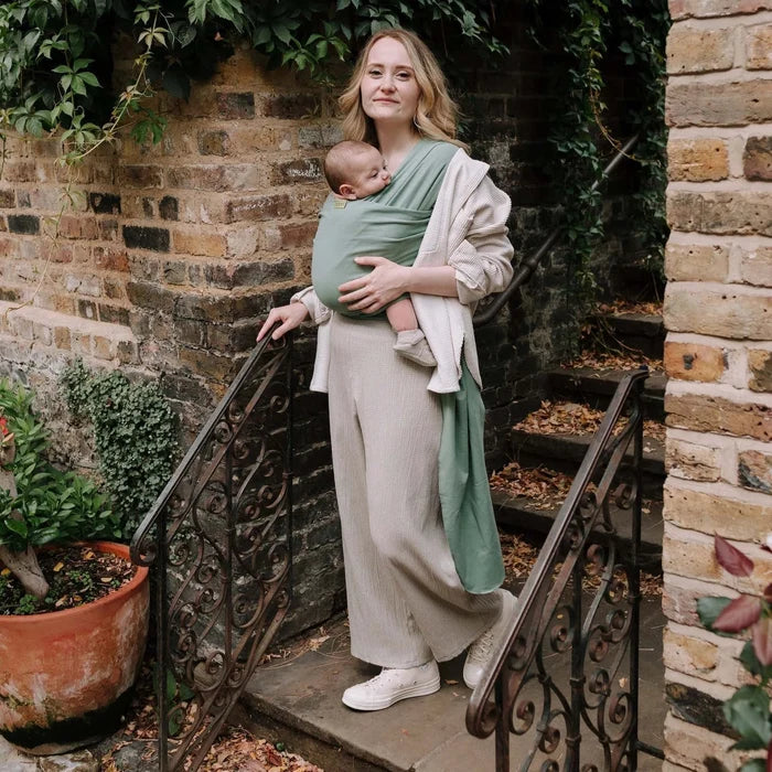 A Boba Classic Baby Wrap, made from a soft 95% French Terry cotton blend and 5% Spandex. Ergonomic, award-winning design fits babies from 7 Ibs to 35 Ibs, best up to 20 Ibs. Machine washable, dryer friendly, and certified hip-healthy. Sage Green