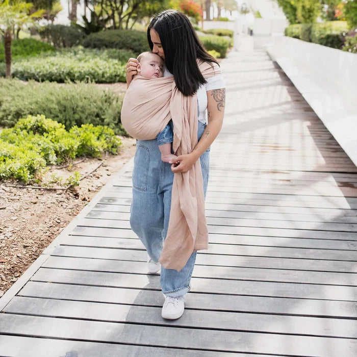 A Boba Ring Sling Baby Carrier made from a unique linen bamboo viscose fabric blend, perfect for all seasons. Lightweight and breathable, it stores compactly, ideal for newborn snuggles to toddler ups and downs (8 - 35Ibs). Peony Pink