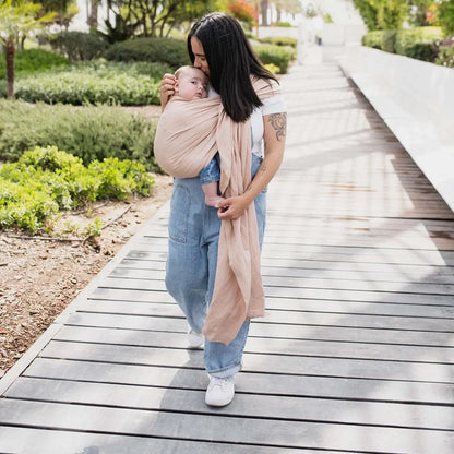 A Boba Ring Sling Baby Carrier made from a unique linen bamboo viscose fabric blend, perfect for all seasons. Lightweight and breathable, it stores compactly, ideal for newborn snuggles to toddler ups and downs (8 - 35Ibs). Peony Pink