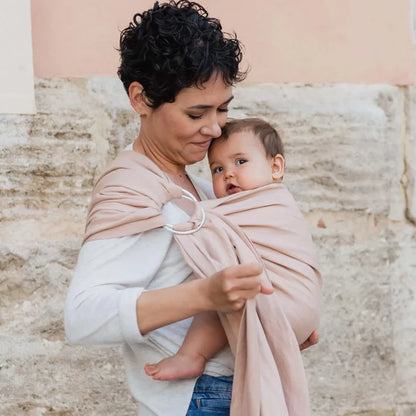 A Boba Ring Sling Baby Carrier made from a unique linen bamboo viscose fabric blend, perfect for all seasons. Lightweight and breathable, it stores compactly, ideal for newborn snuggles to toddler ups and downs (8 - 35Ibs). Peony Pink