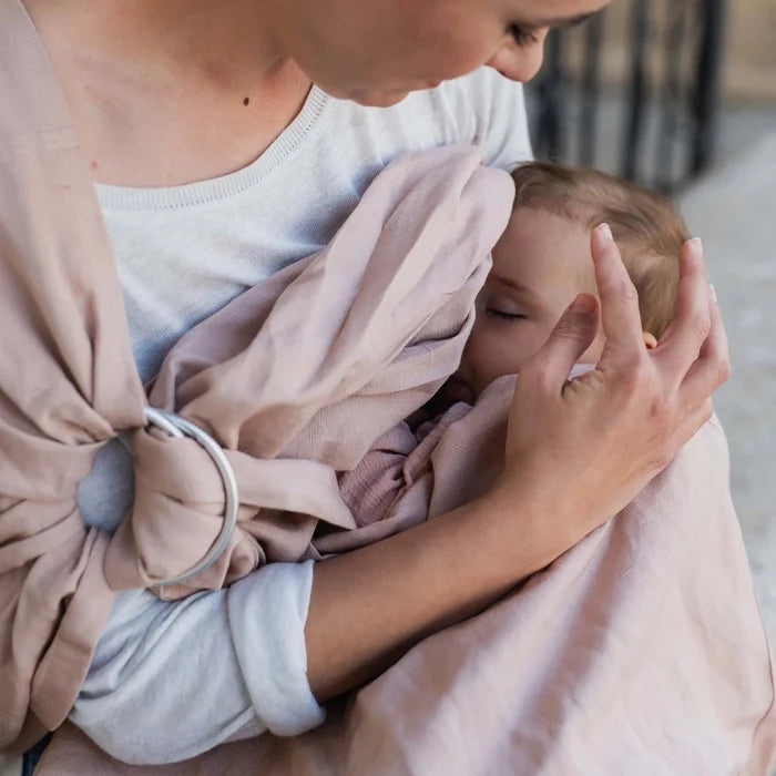 A Boba Ring Sling Baby Carrier made from a unique linen bamboo viscose fabric blend, perfect for all seasons. Lightweight and breathable, it stores compactly, ideal for newborn snuggles to toddler ups and downs (8 - 35Ibs). Peony Pink