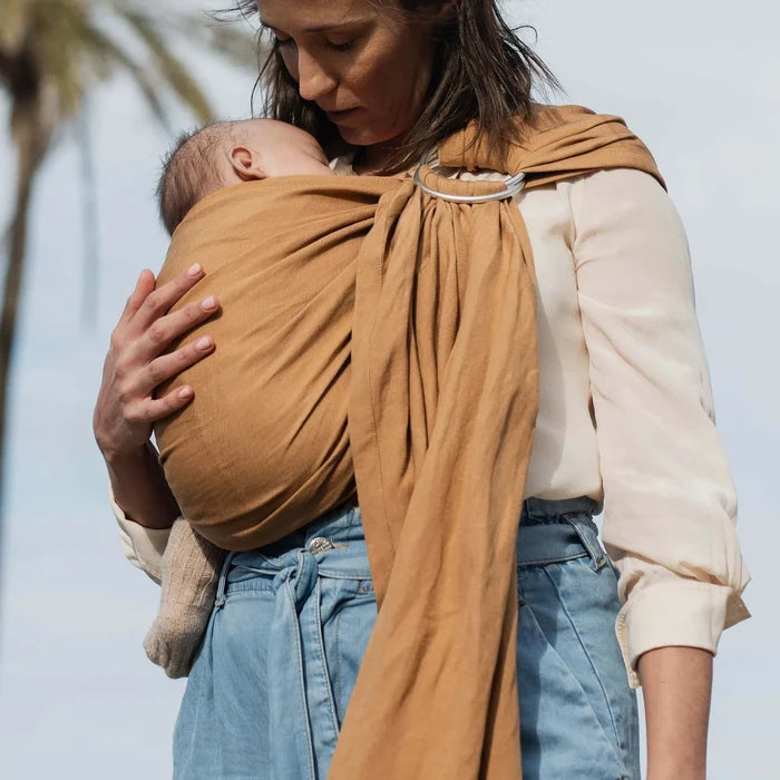 A Boba Ring Sling Baby Carrier made from a unique linen bamboo viscose fabric blend, perfect for all seasons. Lightweight and breathable, it stores compactly, ideal for newborn snuggles to toddler ups and downs (8 - 35Ibs). Rye Brown