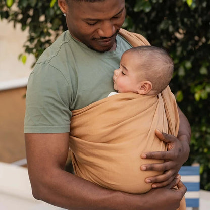 A Boba Ring Sling Baby Carrier made from a unique linen bamboo viscose fabric blend, perfect for all seasons. Lightweight and breathable, it stores compactly, ideal for newborn snuggles to toddler ups and downs (8 - 35Ibs). Rye Brown