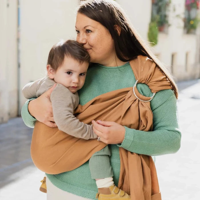 A Boba Ring Sling Baby Carrier made from a unique linen bamboo viscose fabric blend, perfect for all seasons. Lightweight and breathable, it stores compactly, ideal for newborn snuggles to toddler ups and downs (8 - 35Ibs). Rye Brown