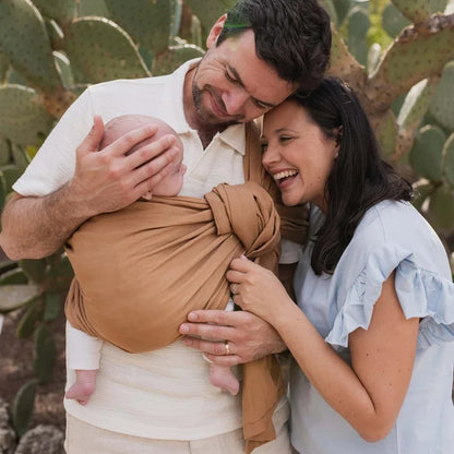 A Boba Ring Sling Baby Carrier made from a unique linen bamboo viscose fabric blend, perfect for all seasons. Lightweight and breathable, it stores compactly, ideal for newborn snuggles to toddler ups and downs (8 - 35Ibs). Rye Brown