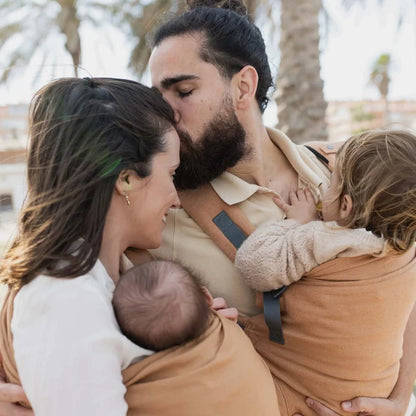 A Boba Ring Sling Baby Carrier made from a unique linen bamboo viscose fabric blend, perfect for all seasons. Lightweight and breathable, it stores compactly, ideal for newborn snuggles to toddler ups and downs (8 - 35Ibs). Rye Brown