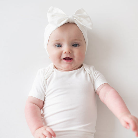 Baby wearing White Bow Headband in Cloud