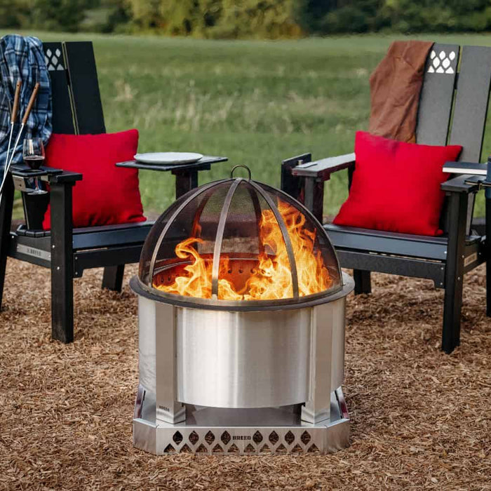 Breeo X Series Chairs set up around a Breeo Firepit with a Base and Spark Screen.