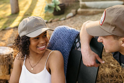 A woman wearing a green Breeo Script Hat