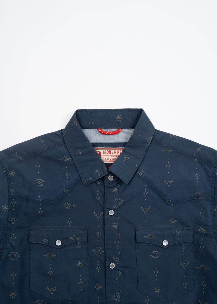 Navy blue western shirt with subtle geometric patterns and silver snap buttons, featuring two chest pockets and a pointed collar.