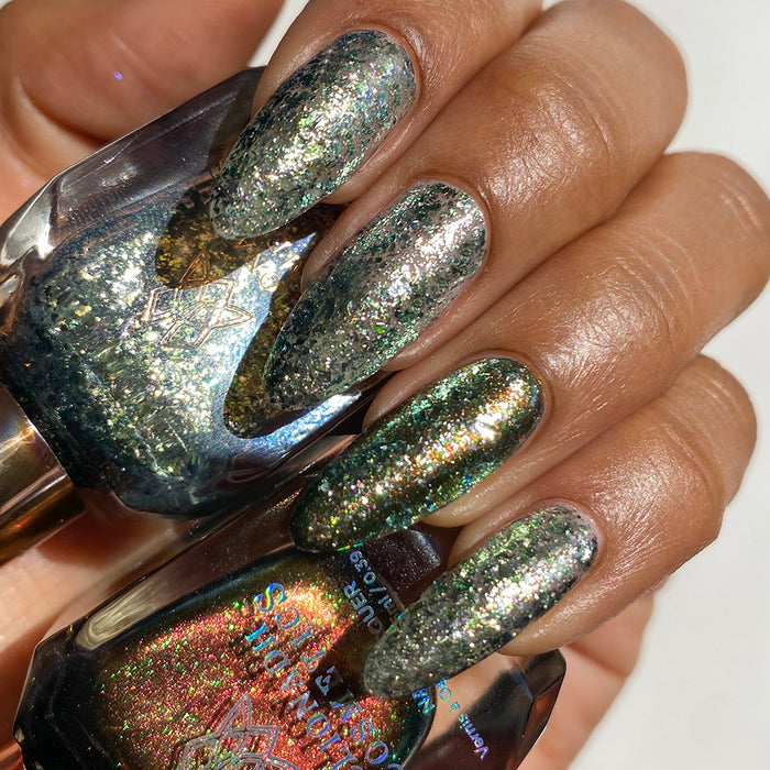 Close-up of nails painted with Catacomb Nail Lacquer on medium skin tone. Hand is holding polish bottle.
