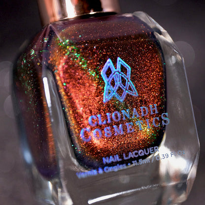 Angled, close-up of Cemetery Nail Lacquer bottle on a black background.