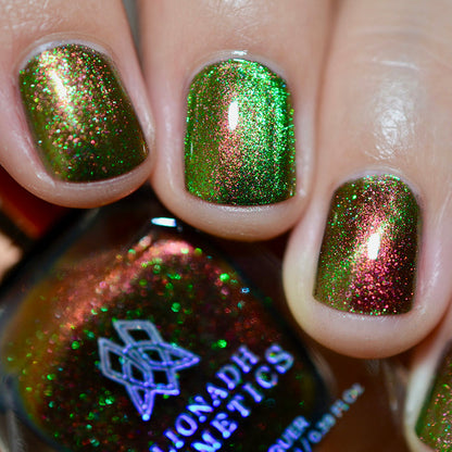Close-up of nails painted with Cemetery Nail Lacquer on fair skin tone. Hand is holding polish bottle.