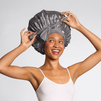 Model wearing KITSCH Charcoal Oversized Satin Bonnet — lifestyle shot — worn while sleeping to protect hair overnight