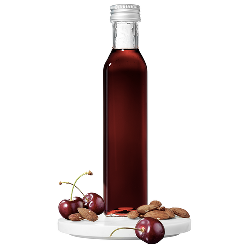 A tall, slender bottle of Cherry Almond Vinegar with a silver cap, accompanied by whole cherries and almonds placed in front.