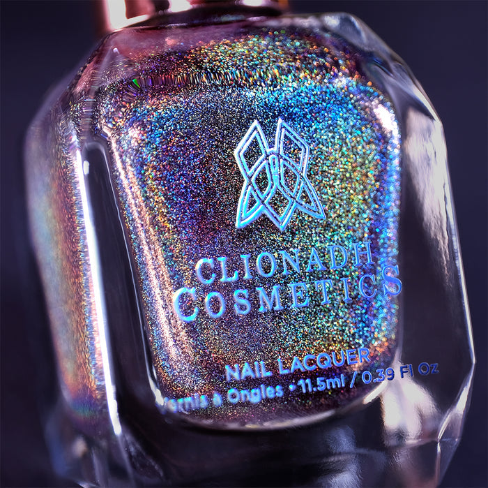Close-up, angled shot of Chocholo Chips Nail Lacquer bottle on a black background.