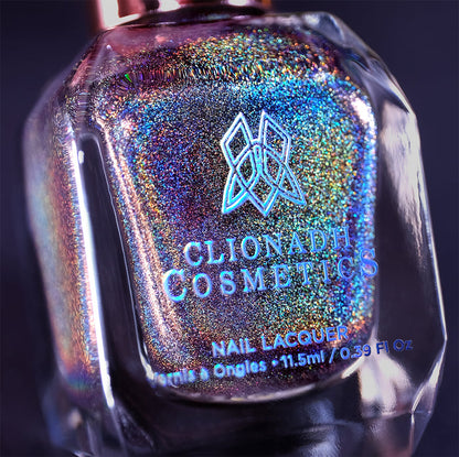 Close-up, angled shot of Chocholo Chips Nail Lacquer bottle on a black background.