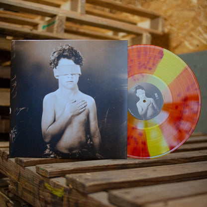 Gideon Yellow & Orange Spinner Limited Edition LP with an album cover featuring a sepia photo of a shirtless, blindfolded child with one hand on their chest, placed on wooden pallets. Ships securely via USPS Priority Mail.